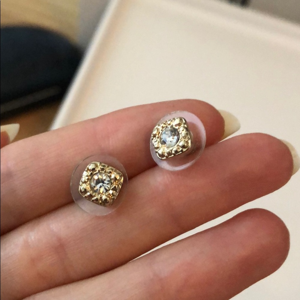 Gold halo stud earrings.
